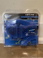 Front view of sealed Park Tool Cyclone CM-5.2 chain scrubber cleaner in clear blister packaging with blue backing card