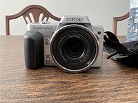 Front view of Sony Cyber-shot DSC-H10 showing lens, branding, and some specifications like 8.1MP, 10x zoom.