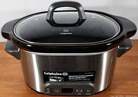 Front view of the Calphalon slow cooker with digital control panel and glass lid in place.