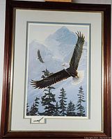 Framed eagle print showing the full artwork with mountainous background and eagle in flight above pine trees.