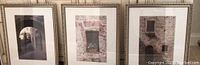 Three framed photo prints of old stone window and door scenes displayed together