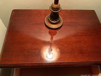 Top surface of night stand showing polished wood with slight wear.