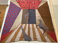 Full view of Friberg Stoffels silk scarf featuring giraffes and zebras in geometric shapes and muted colors.