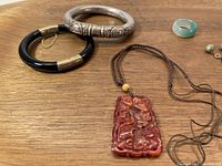 Photo of bracelets, carved pendant necklace, ring, and earrings showing lot contents and details