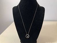 Chain and pendant displayed on black bust showing full necklace