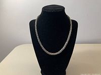 Necklace draped on black display bust showing full length and rope chain pattern