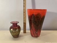Overview of both vases side by side with ruler for scale