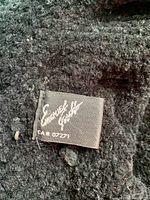 Label of a textured black hat showing brand Emmanuel Gilbert and CA# 07271