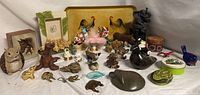 Photo showing the full assortment of animal figurines including owls, elephants, birds, frogs, mice, and boar. Various materials and sizes shown.