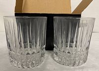 Two Fostoria crystal whiskey glasses side by side in original box, showing overall design and clear condition.
