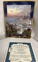 Photo of the plaque showing the San Francisco Lombard Street artwork vividly with city lights and sunset, includes the certificate of authenticity placed in front.