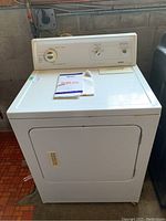 Front view of white Kenmore Special Edition heavy duty electric dryer showing front door and top control panel.