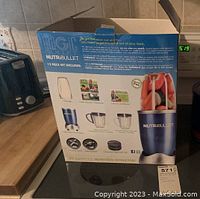 Closed box showing Nutribullet Magic Bullet 12-piece set contents and branding.