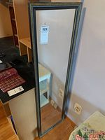 Front view of the full-length rectangular wall mirror showing detailed frame edges.