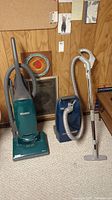Two Kenmore vacuums side by side, upright and canister models visible.