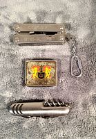 Top view of Coast mini plier set with keychain, Dairy Farmers of Canada metal tape measure featuring crest/logo, Wisers miniature tape measure with corkscrew and keychain.
