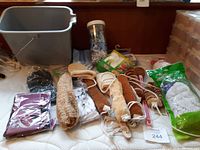 Various cleaning brushes, scrubbing items and replacement mop heads laid out on surface