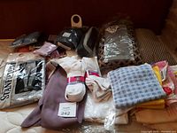 Assortment of socks, underwear, and towel items arranged on a bed