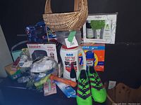 Photo showing various new household and personal items including Admiral fridge, spa set, detergent, soccer shoes, and other