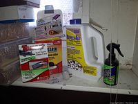 Photo showing various pest control products including rodent repellent container, mouse trap, insect repellent spray, and rodent bait poison.