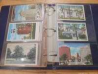 View of two binder pages containing multiple vintage postcards showing various buildings, landmarks, and street scenes.