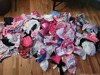 Overview of the large pile of baby and kids clothing showing diversity in colors and types