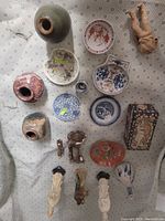 Overview of lot showing multiple ceramic items including vases, plates, small figurines, and decorative pieces.