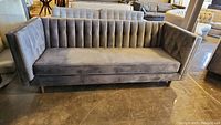 Front angle view showing seat cushion and tufted back