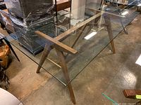 Overall view of rectangular glass top dining table and wood leg base
