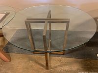 top-down view of table showing round glass top and metal frame base