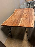 Front corner view showing natural live edge top and black hairpin legs