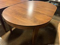 Angle showing the oval top surface and tapered legs.