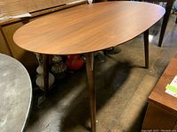 Top view of oval wood veneer tabletop