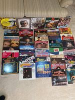 Full collection of vinyl LPs laid out on carpet in rows showing cover art and titles