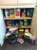 Full view of shelving unit containing assorted garden care items such as bottles, gloves, garden twine, seed trays, and various garden chemical containers.
