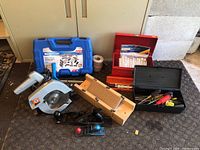 Photo showing the entire tool lot including circular saw, wood planes, toolboxes, and additional tools.