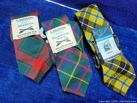 Three new with tags Scottish clan wool neckties by Ingles & Buchan. Made in Scotland from 100% pure new wool. Includes ties in Middleton, Mackintosh (Hunting), and Lochcarron clan tartans.