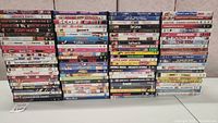 Front view of stacked DVD cases showing titles of comedy movies in the lot.