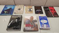 Full view of all eight books in the lot arranged on a carpeted floor
