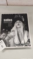 Front cover of the hardcover book featuring black and white image of a woman with long blonde hair making a kiss face, title, and author name visible.