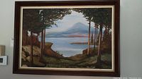 Full view of the framed original acrylic painting showing water, mountain, and tree landscape