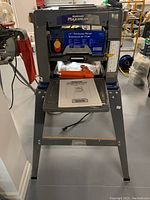 Front view of Mastercraft Maximum 13" thickness planer mounted on steel stand