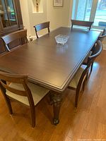 Rectangular dining table with eight chairs set around it, crystal bowl center