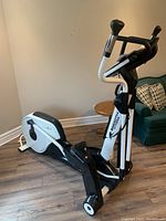 Angled side view of entire elliptical on wood floor