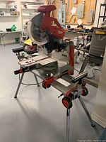 Full view of miter saw mounted on stand in workshop