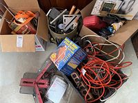 General overview of contents showing tools, cords, boxed Magic Mitre, red jack/clamp and other hardware
