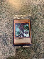 Photo of sealed holographic Dark Magician Yu-Gi-Oh! trading card on textured surface
