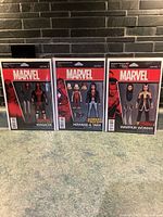 Front view of 3 Marvel Comics action figures in packaging: Deadpool Masacre, Howard & Tara, Warrior Woman