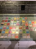 Full layout of Pokémon cards including energies, holograms, and some Japanese cards.