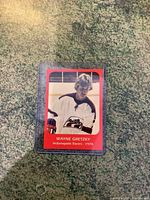 Front of Wayne Gretzky 1978 Indianapolis Racers hockey card showing his image in jersey and red border.